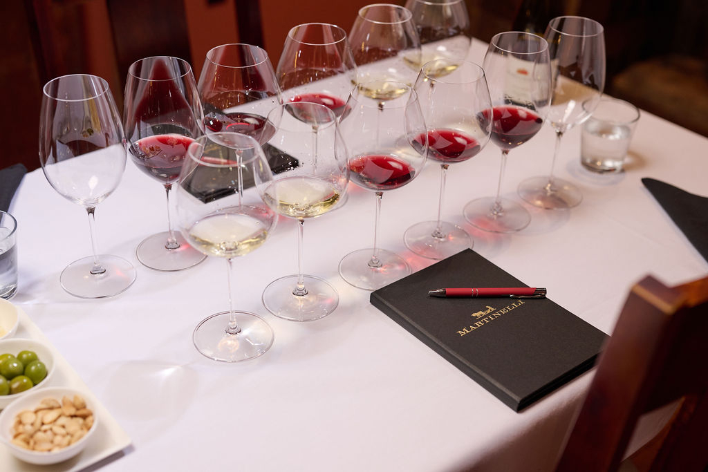 red and white wine flight on table with white linen